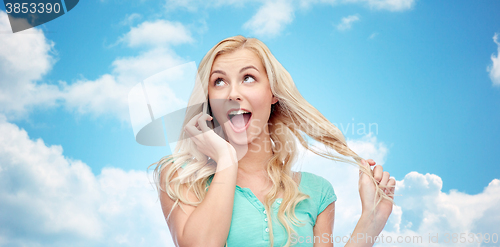 Image of smiling young woman calling on smartphone