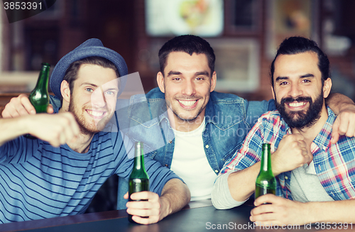 Image of happy male friends drinking beer at bar or pub