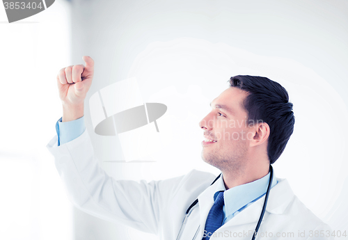 Image of young doctor holding something imaginary