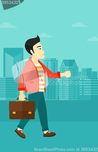 Image of Businessman walking with briefcase. 