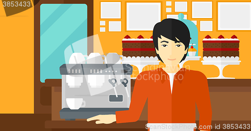 Image of Barista standing near coffee maker.