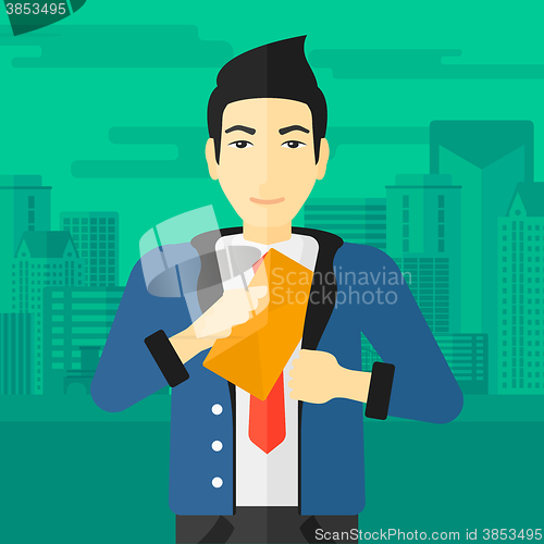 Image of Man putting envelope in pocket.