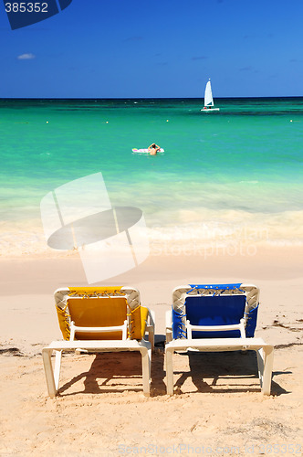Image of Chairs on sandy tropical beach