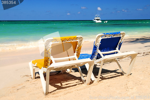 Image of Chairs on sandy tropical beach