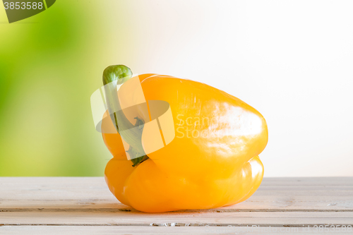 Image of Yellow pepper on a wooden table