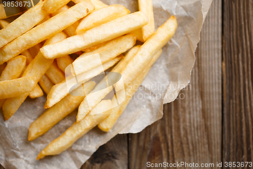Image of Fresh french fries on wooden background