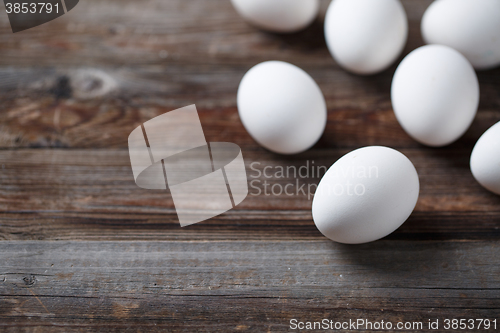 Image of White eggs on the old wood table