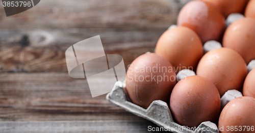 Image of Brown eggs on a rustic wooden table