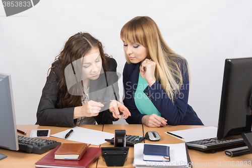 Image of Young office workers enthusiastically discussing lipstick at your desk