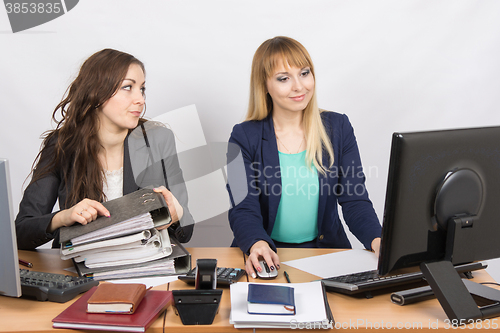 Image of Office employee asks for help from colleagues at work with papers and documents