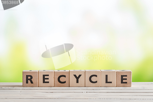 Image of Recycle sign on a wooden table