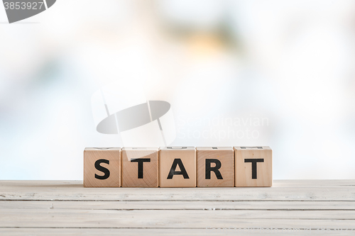 Image of Start sign on a wooden table