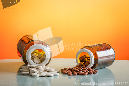 Image of Two kinds of pills in glasses