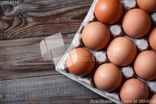 Image of Brown eggs on a rustic wooden table