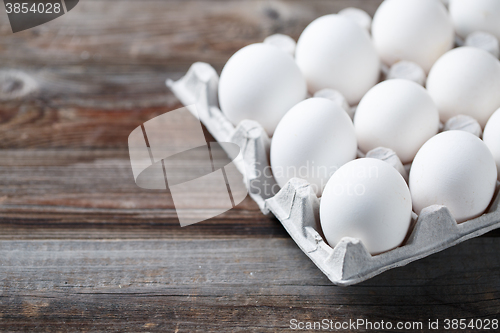 Image of White chicken eggs on old wooden table