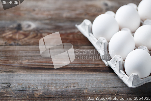 Image of White chicken eggs on old wooden table