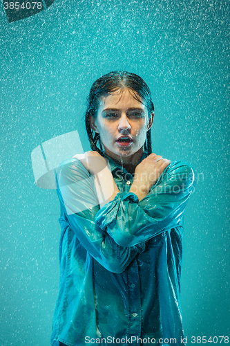 Image of The portrait of young beautiful woman in the rain