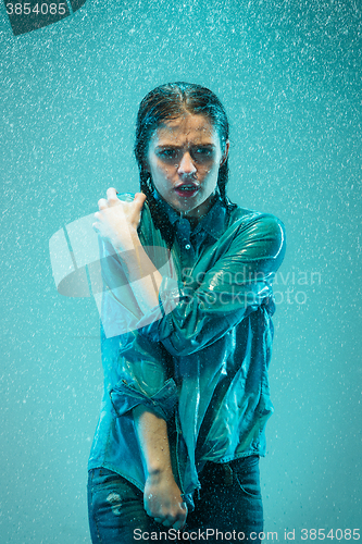 Image of The portrait of young beautiful woman in the rain