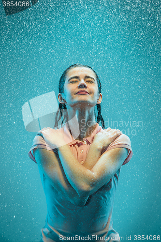 Image of The portrait of young beautiful woman in the rain