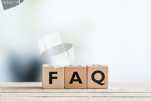 Image of FAQ sign on an office table