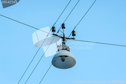 Image of Old street lamp hanging on wires