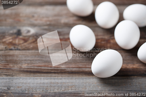 Image of White eggs on the old wood table