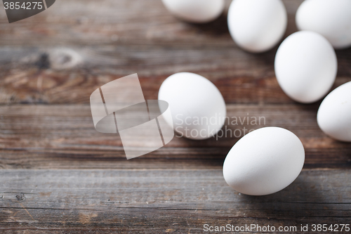 Image of White eggs on the old wood table