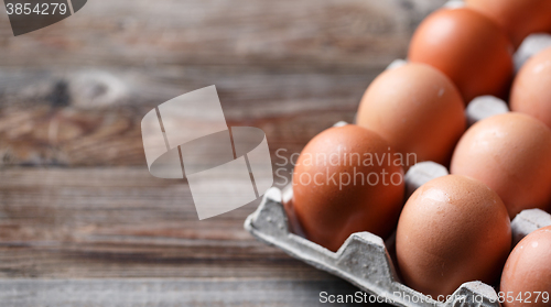 Image of Brown eggs on a rustic wooden table