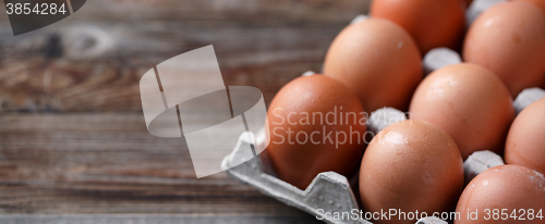 Image of Brown eggs on a rustic wooden table