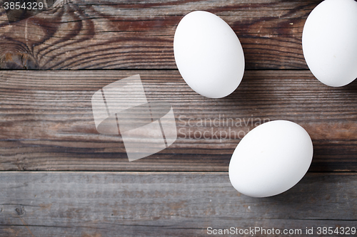 Image of White eggs on the old wood table