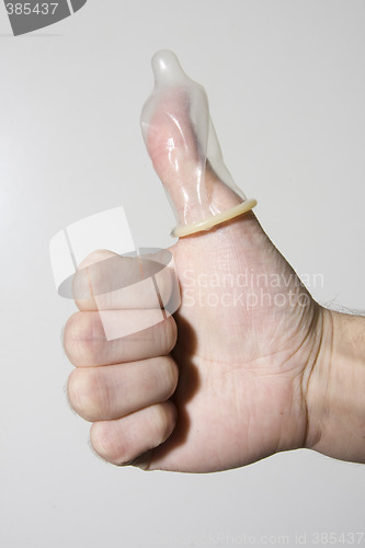 Image of hand holding condom