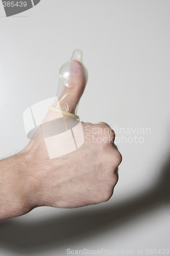 Image of hand holding condom