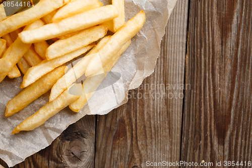 Image of Fresh french fries on wooden background