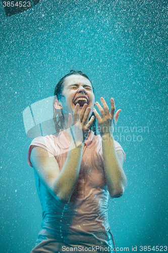Image of The portrait of young beautiful woman in the rain