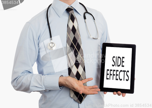 Image of Doctor holding tablet - Side effects