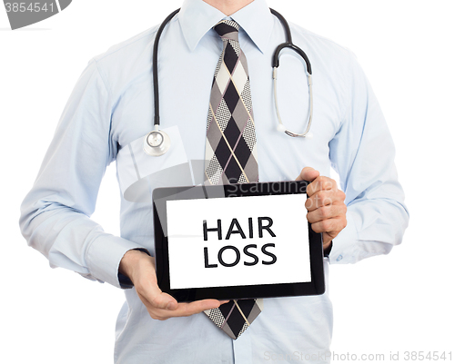 Image of Doctor holding tablet - Hair loss