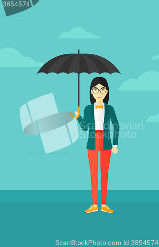 Image of Business woman standing with umbrella.