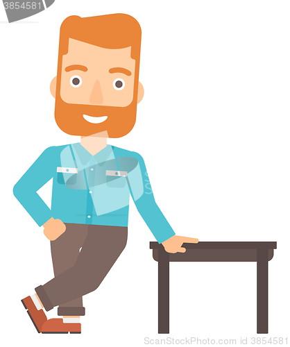 Image of Man leaning on table.