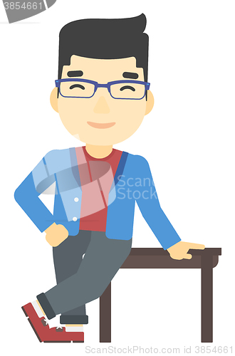 Image of Man leaning on table.