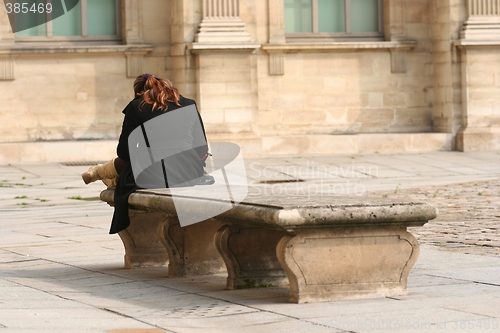 Image of Young woman on a bench