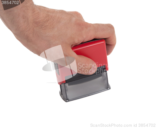 Image of Plastic stamp in hand, isolated