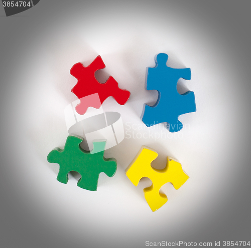 Image of Closeup of 4 big jigsaw puzzle pieces