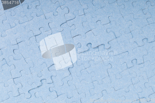 Image of Connected blue puzzle pieces isolated