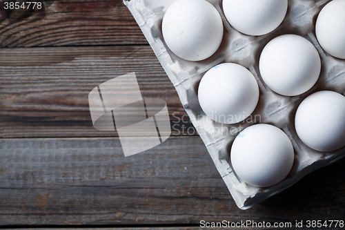 Image of White eggs on a rustic wooden table