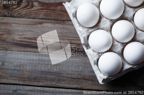 Image of White eggs on a rustic wooden table