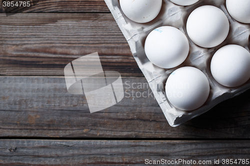 Image of White eggs on a rustic wooden table