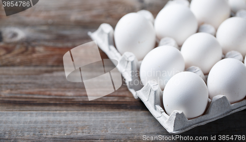 Image of White eggs on a rustic wooden table