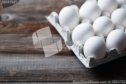Image of White eggs on a rustic wooden table