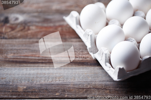 Image of White eggs on a rustic wooden table