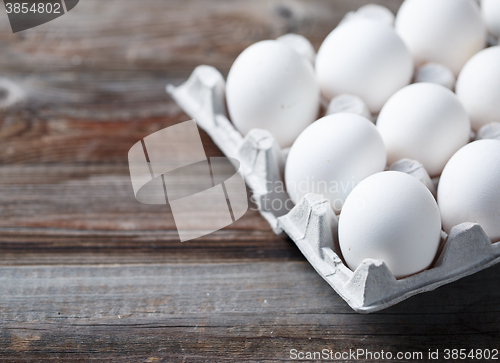 Image of White eggs on a rustic wooden table